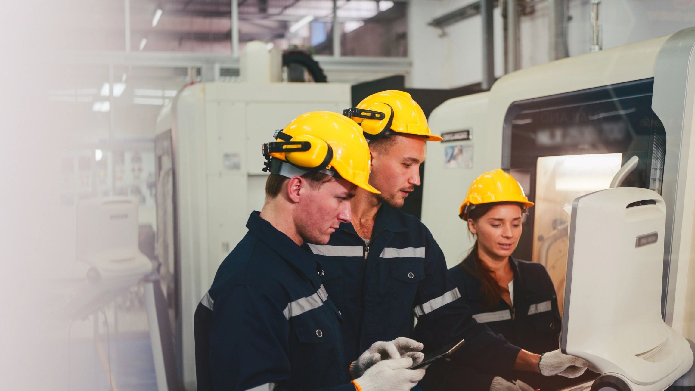 Engineer using tablet to inspect industrial machinery