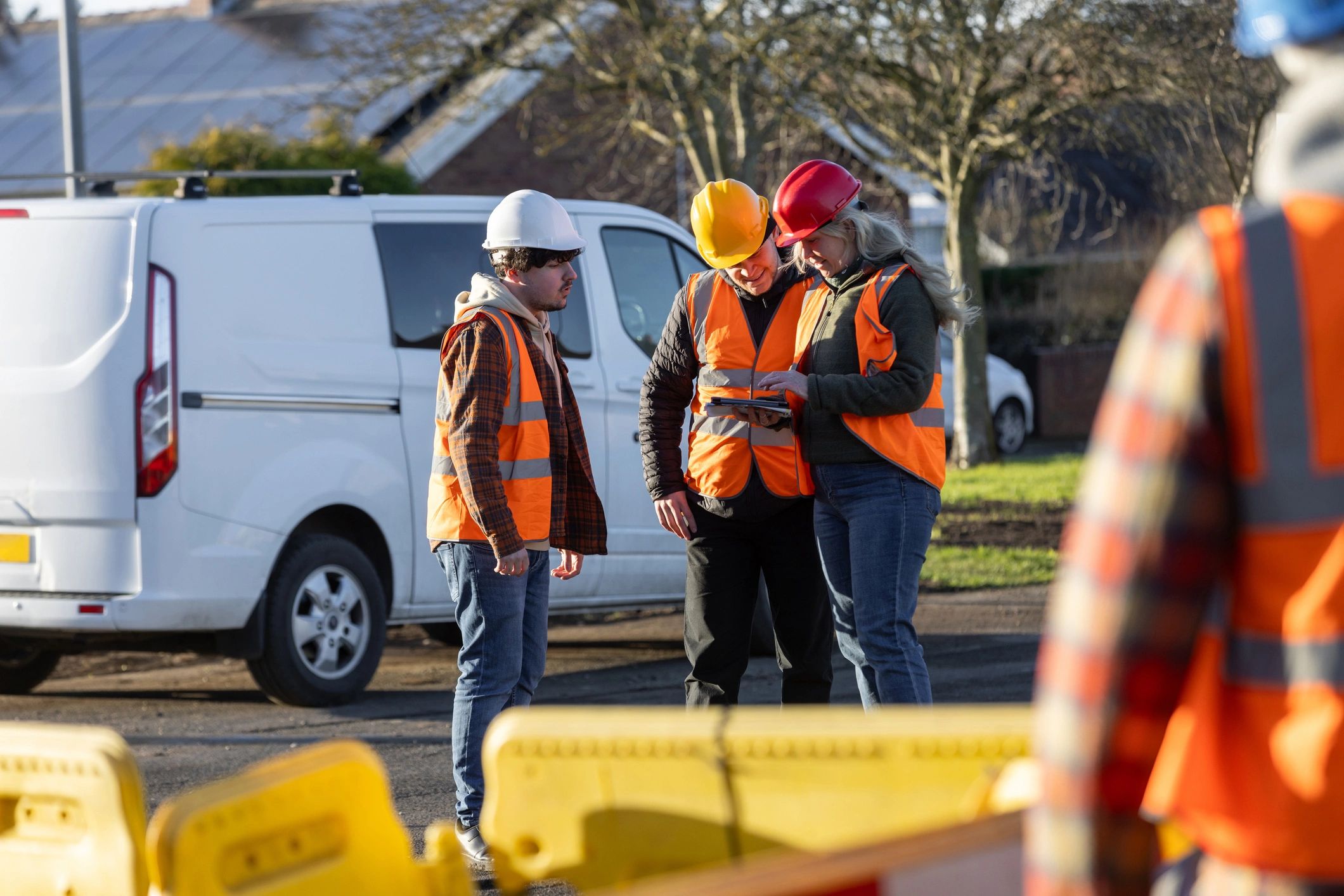 Operations team discussing worksite planning in safety gear