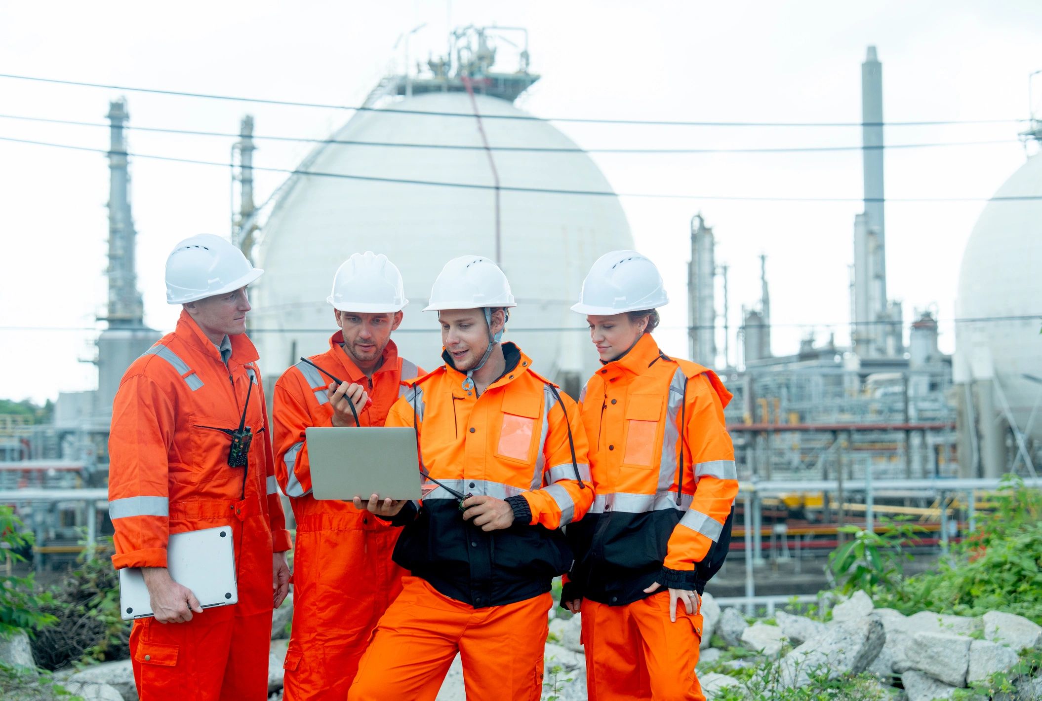 Field engineers and technicians discussing operations at an industrial site