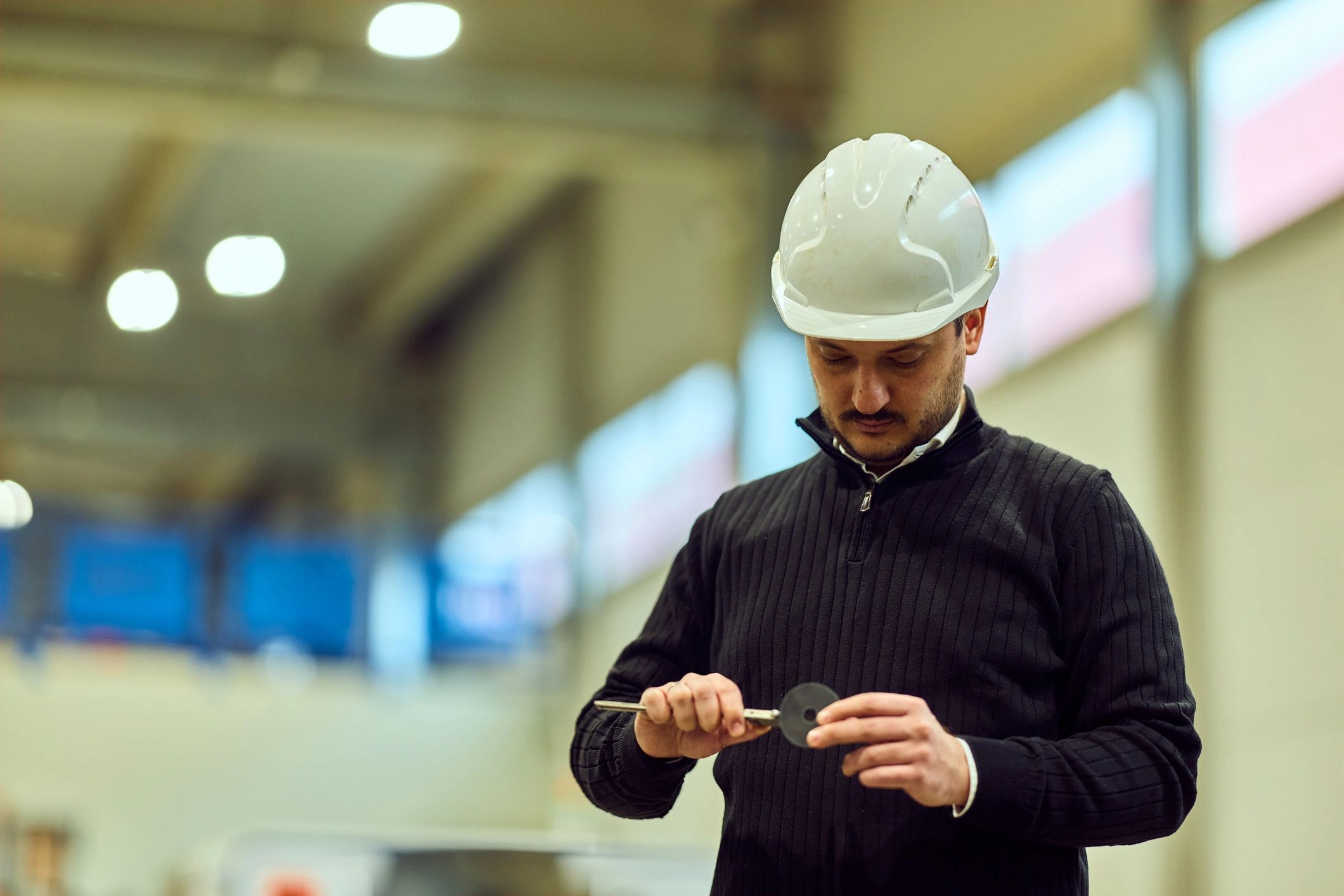 Industrial engineer inspecting equipment component for quality and readiness
